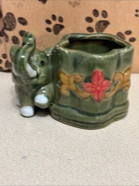 Vintage green majolica ceramic elephant planter with a "lucky trunk up" design.